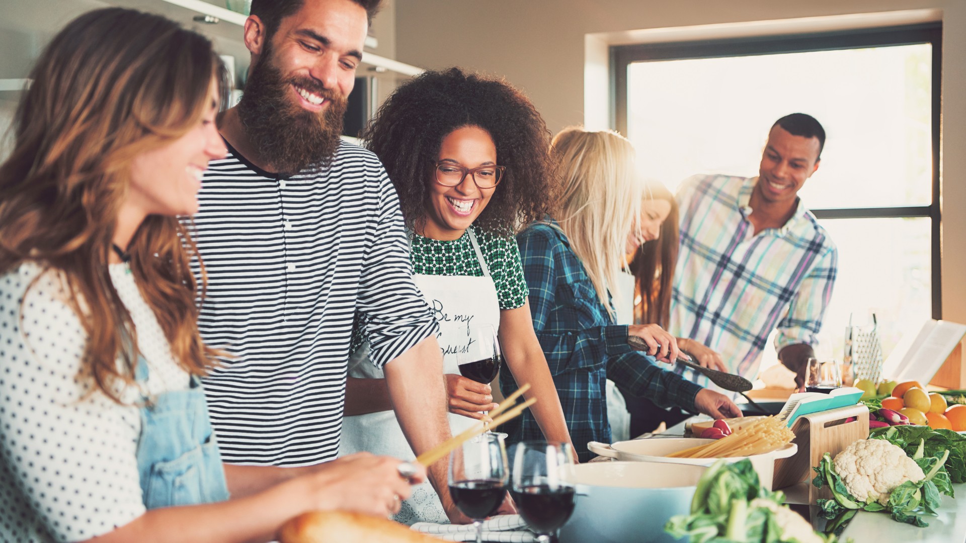 a group of people standing around a table
